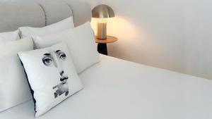 a bedroom with a bed with a dog pillow at La Maison de La Plage in Le Grau-dʼAgde +28 photos