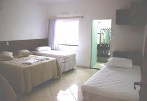 Postel nebo postele na pokoji v ubytování Hotel Dorta's