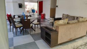 a living room with a couch and a table with chairs at DatsunG Studios Near Pune Airport in Pune