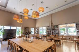a restaurant with wooden tables and chairs and windows at Howard Johnson by Wyndham Funes in Funes