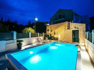 a swimming pool in a backyard at night at Apartments Azzurro- One Bedroom Apartment with Terrace and Hot Tub in Komolac +32 photos
