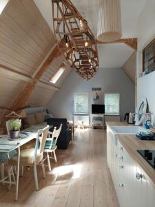 a kitchen and living room with a table and chairs at 3rd floor Loft in Historical Dordrecht in Dordrecht