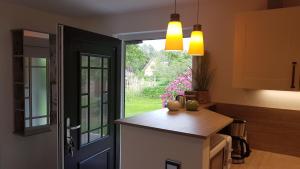 a kitchen with a door leading to a garden at Spreewaldferienhaus Kupa in Burg