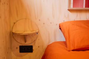 a corner of a bedroom with a mirror and a bed at Tetris Tiny House in Den Bosch +3 photos