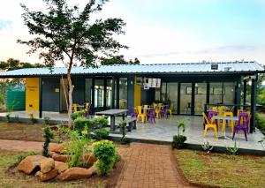 a building with colorful chairs and tables on a patio at SleepOver Punda Maria Gate in Punda Maria