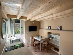 a kitchen with a table and a sink and a fireplace at The House of Love in Bellano