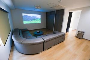 a living room with a couch and a table at HOTEL ALL IN Kumamoto in Kumamoto