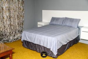 a bedroom with a bed with blue pillows at KSG GuestFarm in Eikenhof +7 photos