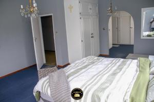a bedroom with a large bed in a room at KSG GuestFarm in Eikenhof