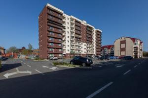 a parking lot with a large apartment building at Rezidential Park Letea by Rooms in Bacău