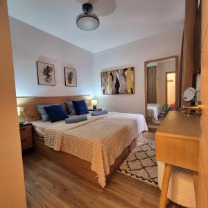 a bedroom with a large bed with blue pillows at Natalia - Melrose Place in Arona +24 photos