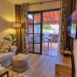 a living room with an open door to a patio at Natalia - Melrose Place in Arona