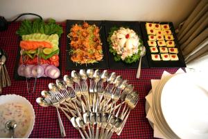 a table topped with lots of different types of food at Tranquil Riverview Inn in Kottayam
