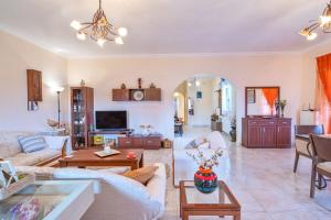 a living room with a couch and a table at Pasiphae Holiday Apartments in Kontokali