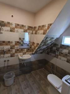 a bathroom with a sink and a toilet at Nautical Escape Home Stay in Puducherry