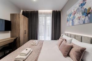 En eller flere senge i et værelse på DeMar Apart Lilac