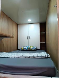 a bedroom with a large bed with a cabinet at MiniRoom 1 khách tại Vinhome Grand Park in Ho Chi Minh City