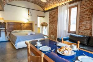 a bedroom with a bed and a table with food on it at lovingenoa Light - Passion in Genoa