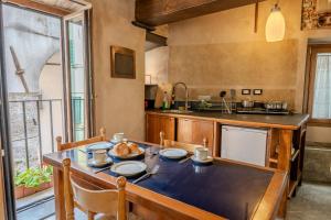 a kitchen with a large wooden table with chairs at lovingenoa Light - Passion in Genoa