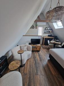 a living room with a couch and a tv at Bij ons op de Hoep. in Schagen