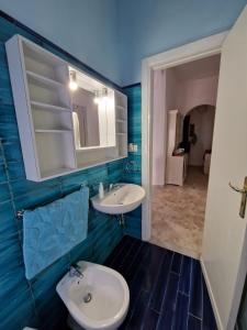 a bathroom with a white sink and a mirror at Casa Cristina in Maiori +16 photos
