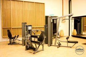 a gym with cardio equipment and treadmills at Lucentia Residence by EAS Maju property in Kuala Lumpur +130 photos