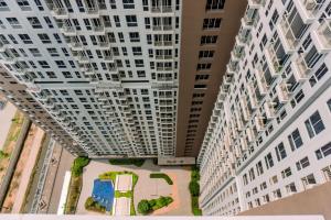 an overhead view of two tall white buildings at Nice and Comfort Studio Apartment at Tokyo Riverside PIK 2 By Travelio in Rawalembang