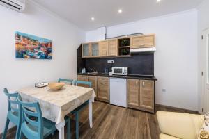 a kitchen with a table and chairs in a room at E-home Apartments in Varna City