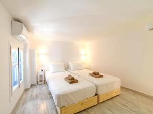 a bedroom with two beds with hats on top of them at 2-bedroom LOFT apartment in Megali Ammos