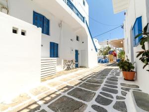 a stone walkway with white buildings and plants on it at 2-bedroom LOFT apartment in Megali Ammos
