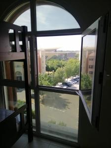 an open window with a view of a parking lot at The Gardens home in Dubai