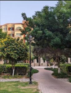 a street light in front of a building with trees at The Gardens home in Dubai