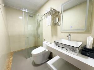 a bathroom with a toilet and a sink and a shower at A25 Hotel - Hoàng Đạo Thúy 2 in Hanoi +14 photos