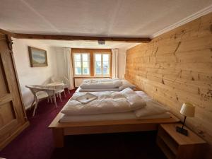 two beds in a room with a wooden wall at Bergengel in Scharnachtal  +20 photos
