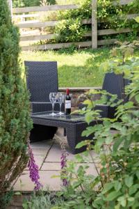 a table with two glasses and a bottle of wine at Ash Cottage, Castle Carrock, Nr Carlisle in Castle Carrock