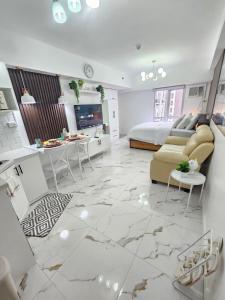 a living room with a large marble floor at Steff's Condo 722 at Centrio Tower in Cagayan de Oro +7 photos