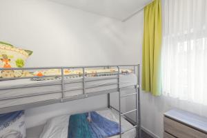 a small bedroom with a bunk bed and a window at Ferienquartier- Forsthaus in Bad Gottleuba