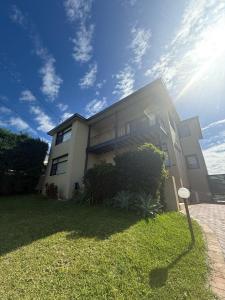 a large house with the sun in the sky at Spacious Queen Room with Private Balcony - GA4 in Chullora