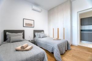 a bedroom with two beds with pillows on them at Prestige 401 2 BED in Paphos +28 photos