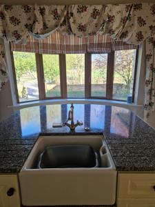 a kitchen sink in front of a window at Farm House Cottage in Baltinglass +21 photos