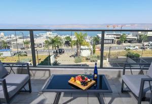 a plate of food on a table on a balcony at Michelangelo Kinneret Family Apartment in Tiberias