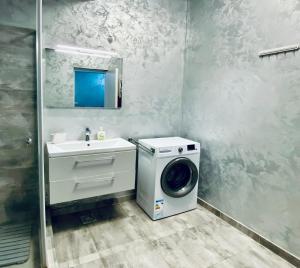 a bathroom with a washing machine and a sink at Hello Sunshine in Năvodari