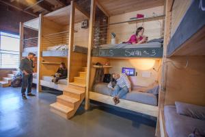 a group of people in bunk beds in a room at PodShare DTLA in Los Angeles