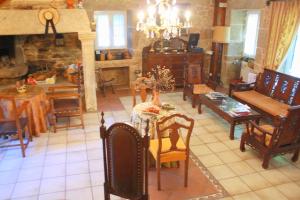 a large living room with a table and chairs at Casa de Turismo Rural Os Petroglifos in Boiro +29 photos