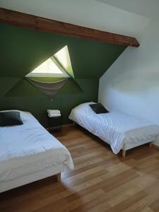 a green room with two beds and a window at Sweethome – La Jacqueminière in Courtenay +22 photos