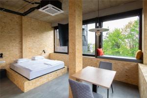 a bedroom with a bed and a table and a window at Headline apartments in Ljubljana +33 photos