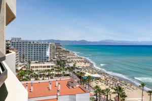 a view of a beach with a hotel and the ocean at Sol Puerto Marina in Torremolinos
