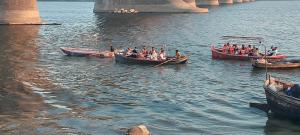 a group of people in boats on the water at Cozy haven stays in Prayagraj