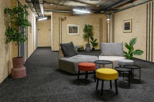 a room with a couch and chairs and tables at Headline apartments in Ljubljana