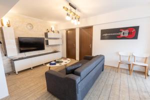 a living room with a couch and a tv at MaraM in Constanţa